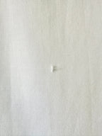 Close-up of a textured white fabric surface