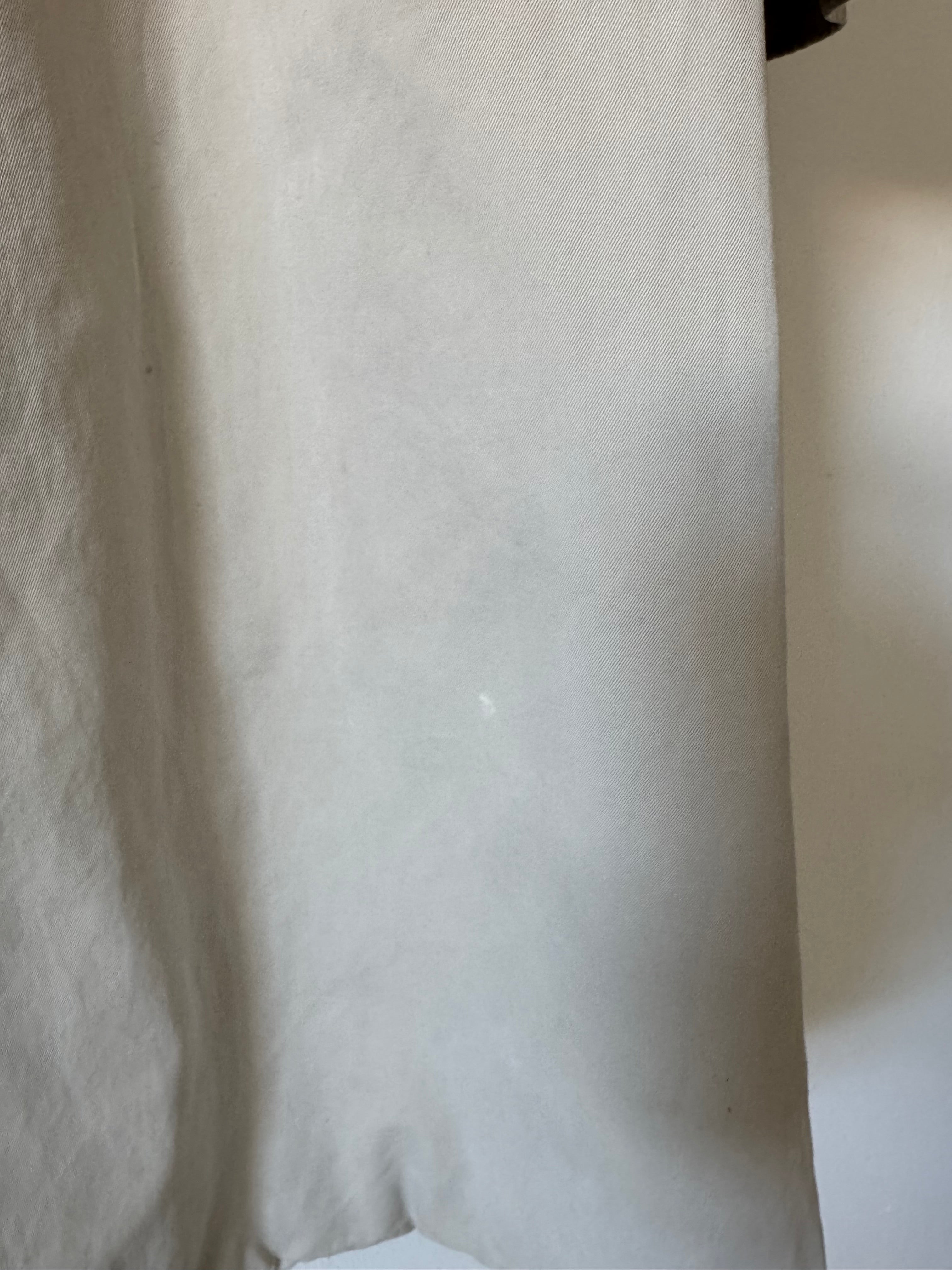 Close-up of a textured beige trench coat