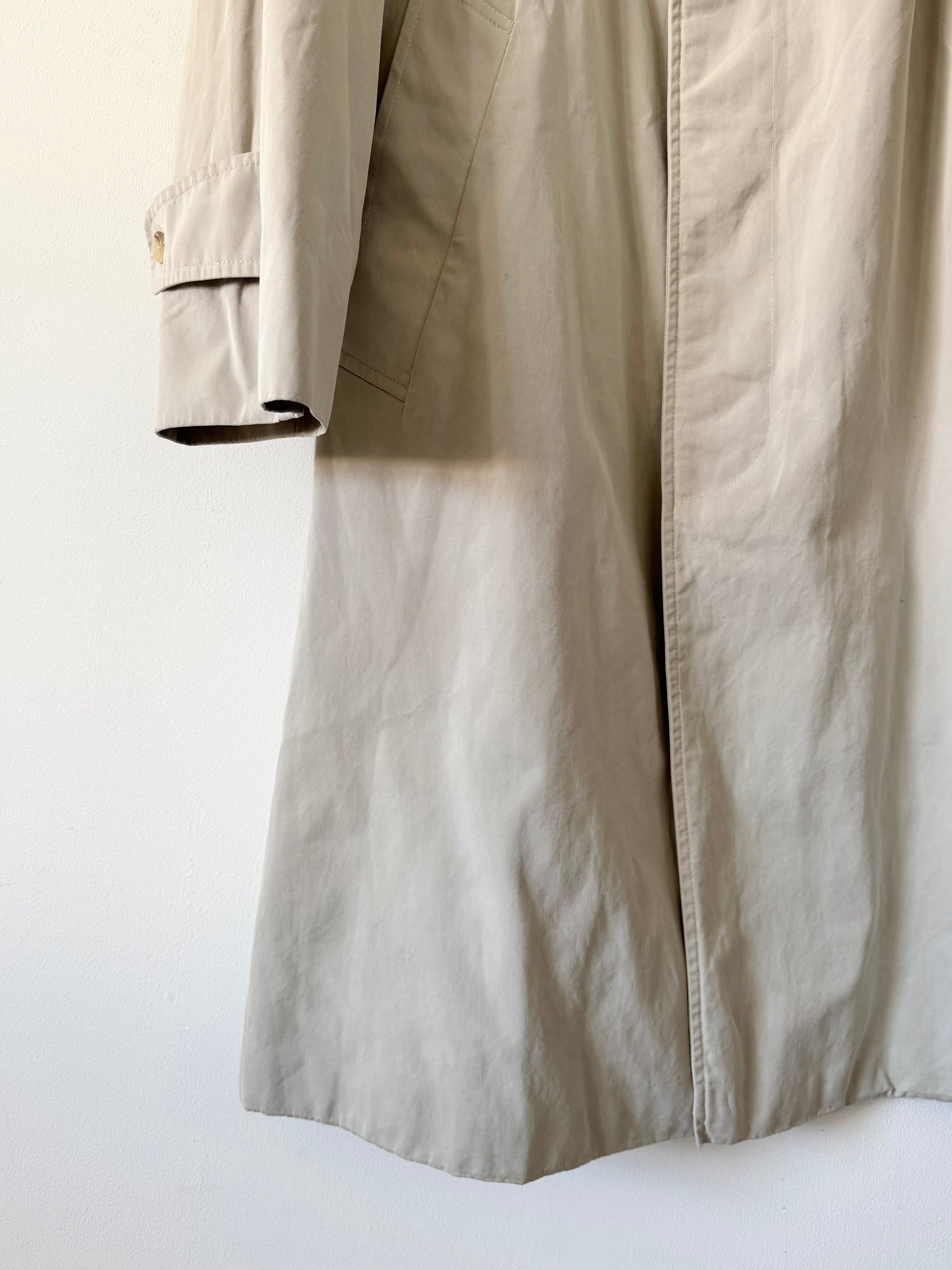 Beige trench coat on a white background