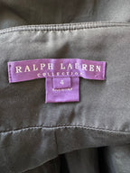 Close-up of a Ralph Lauren Collection garment label sewn onto dark gray fabric, with a size 4 tag below it.