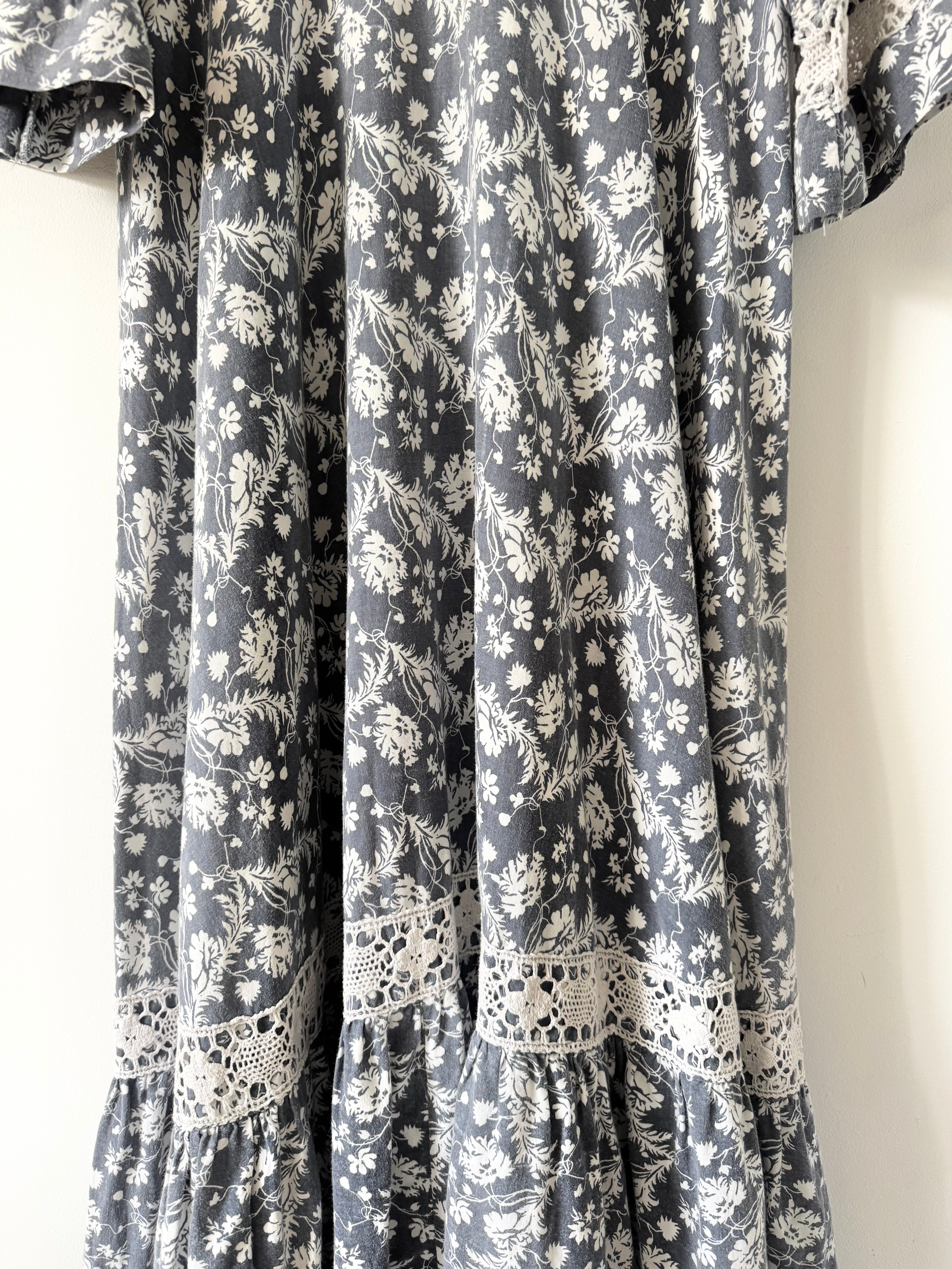 Floral patterned dress with lace details on a plain background