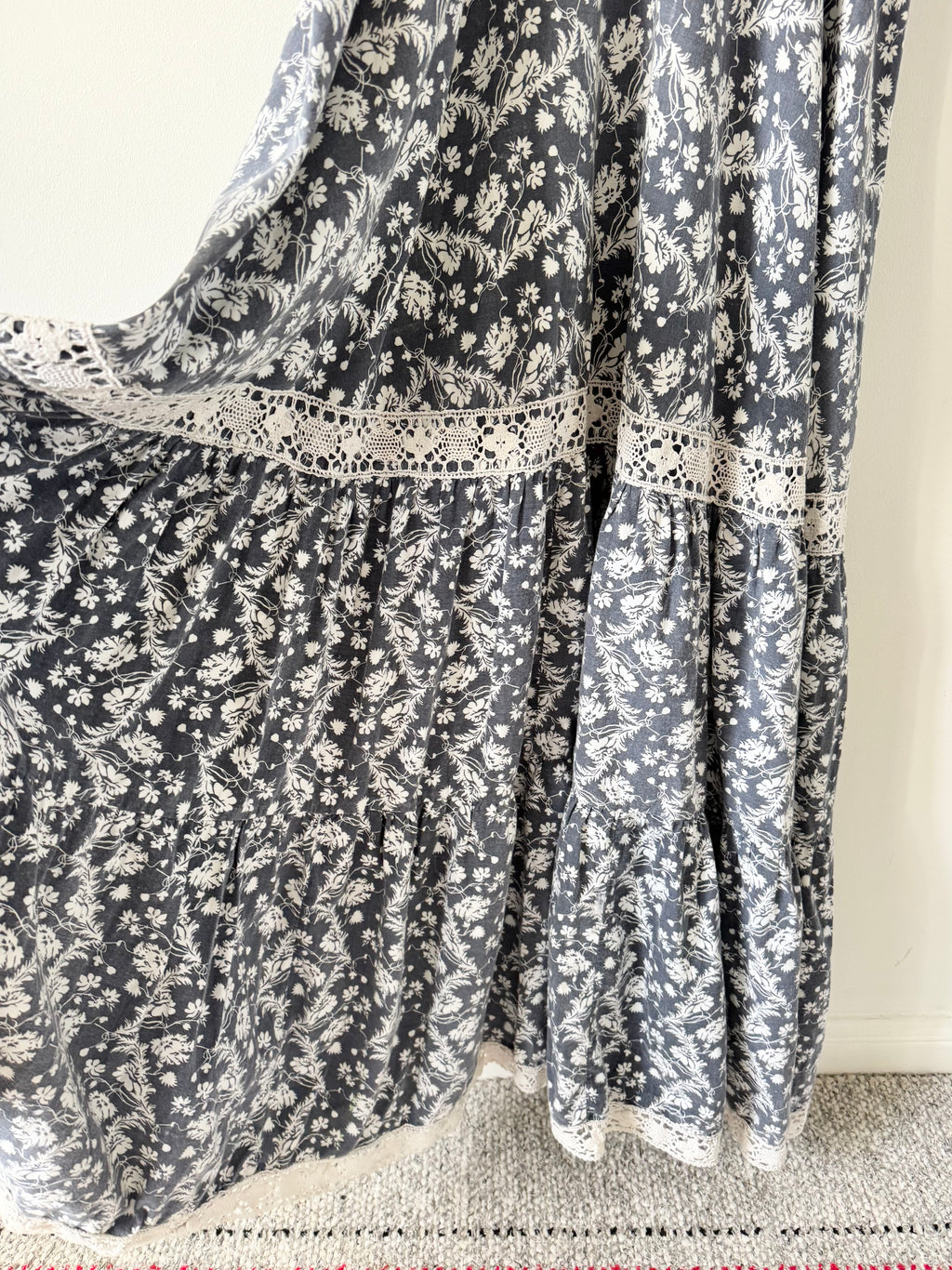 Floral patterned fabric draped over a surface with a neutral background