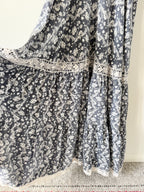 Floral patterned fabric draped over a surface with a neutral background