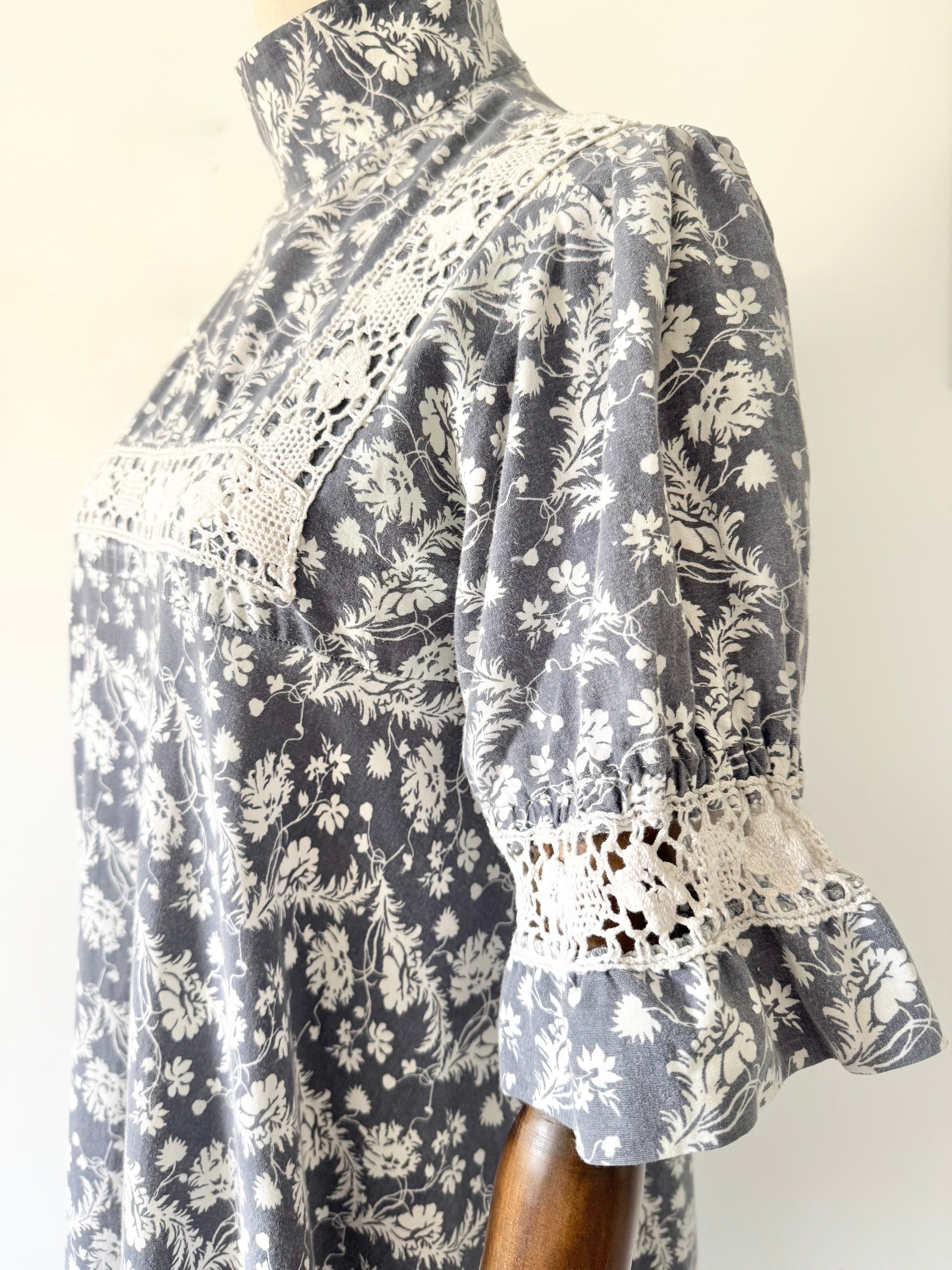 Floral patterned dress with lace details on a plain background