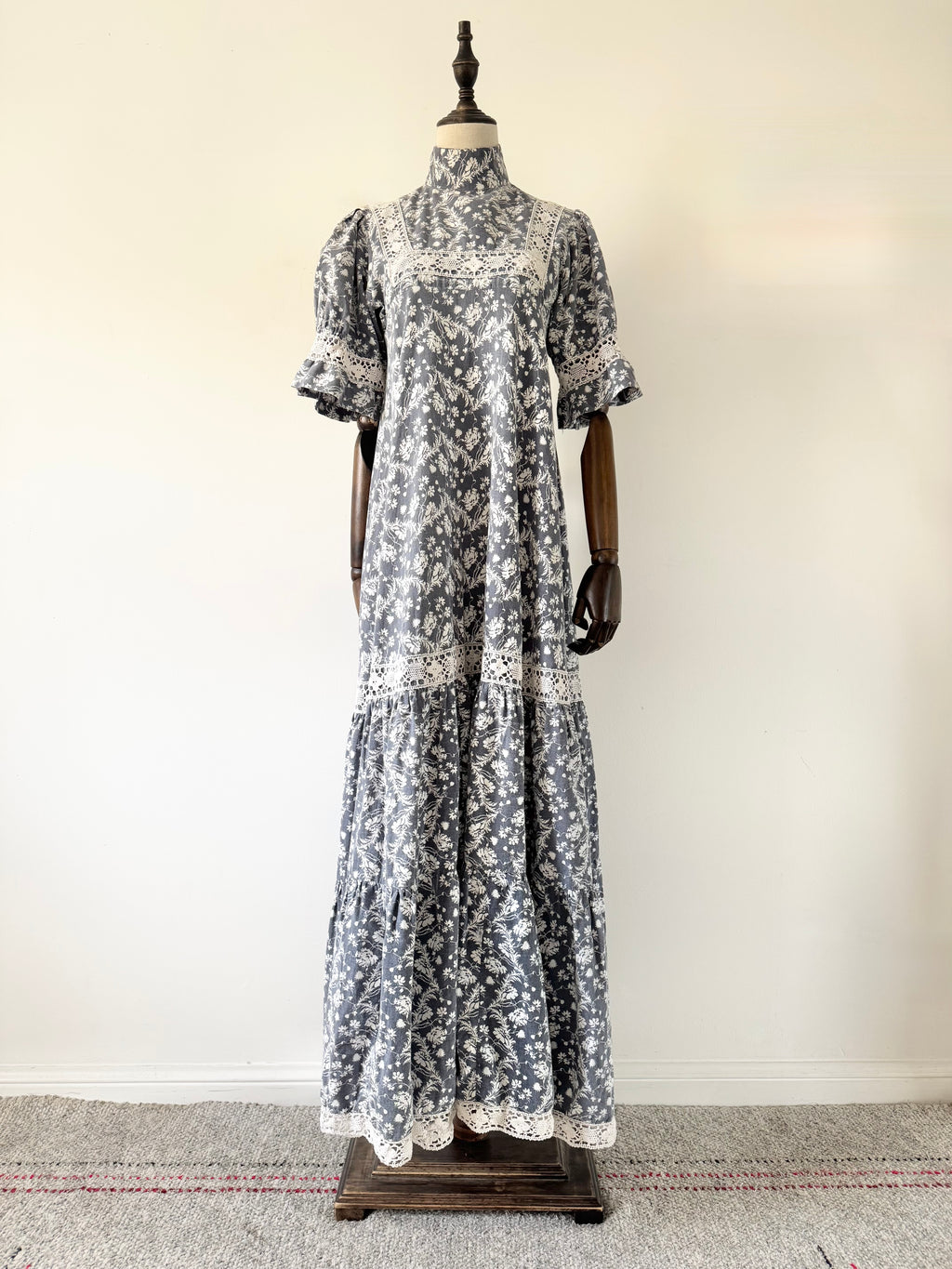 Floral dress on a mannequin against a white wall