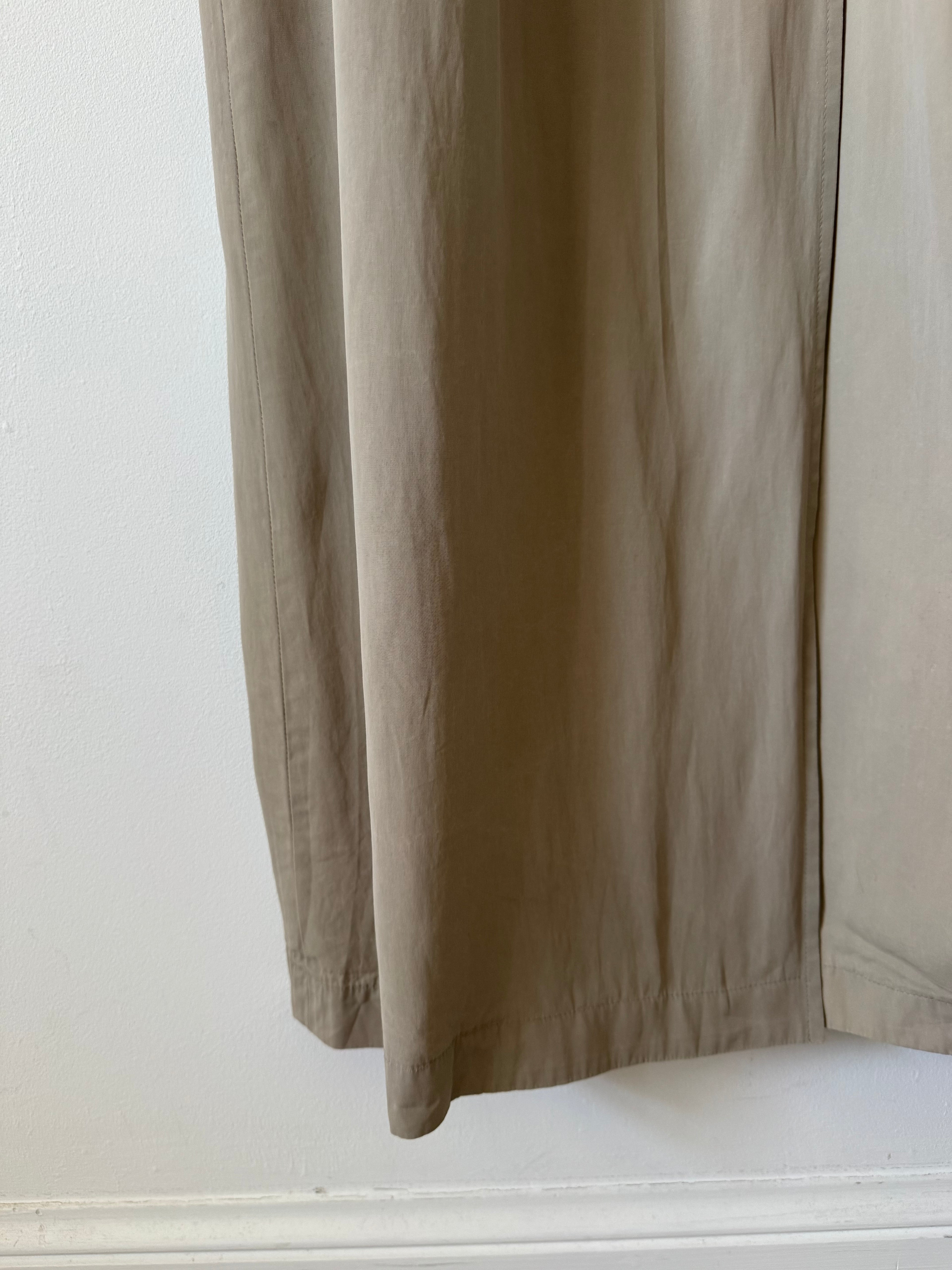 Close-up of beige trench on a white background