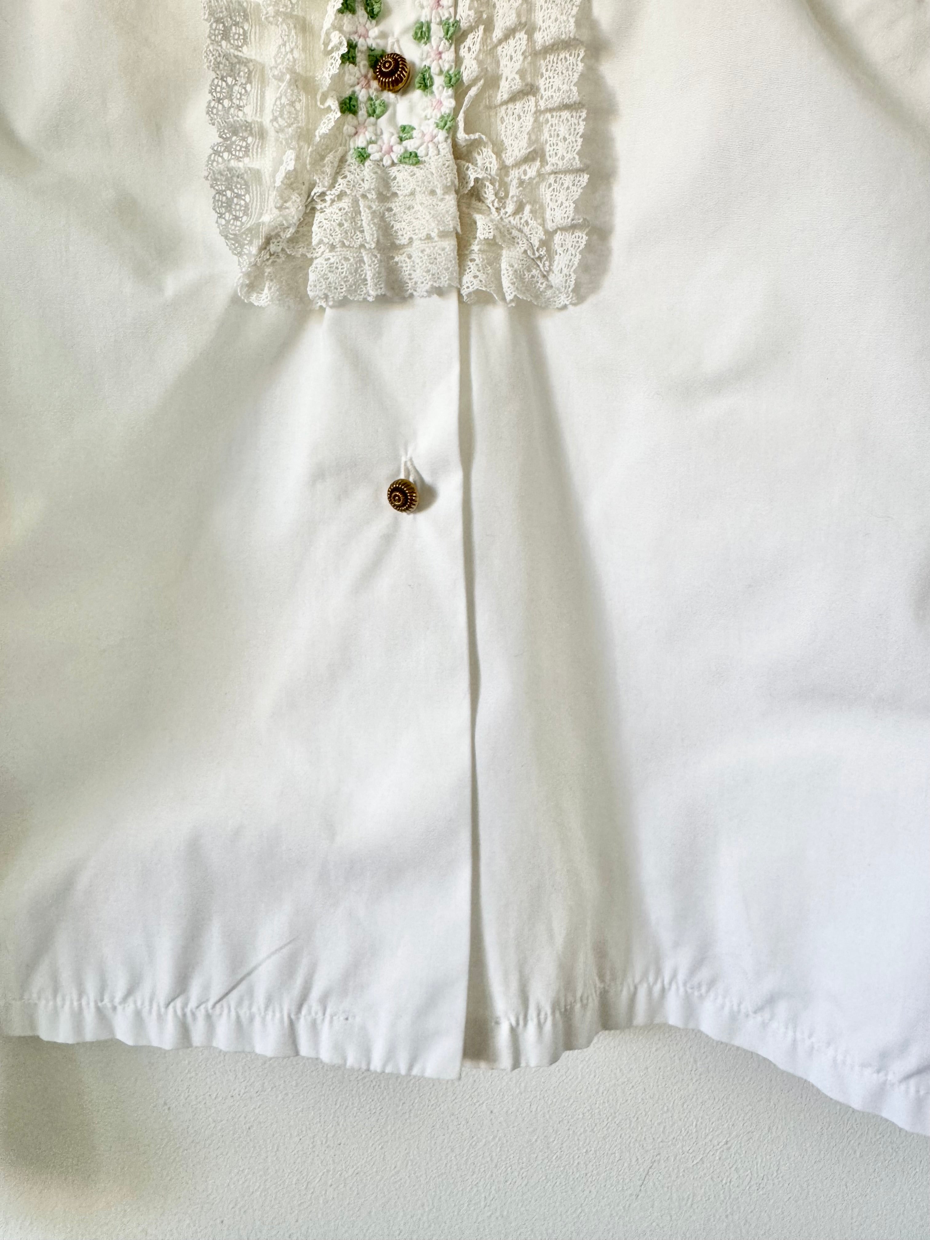 White blouse with lace detailing on a white background