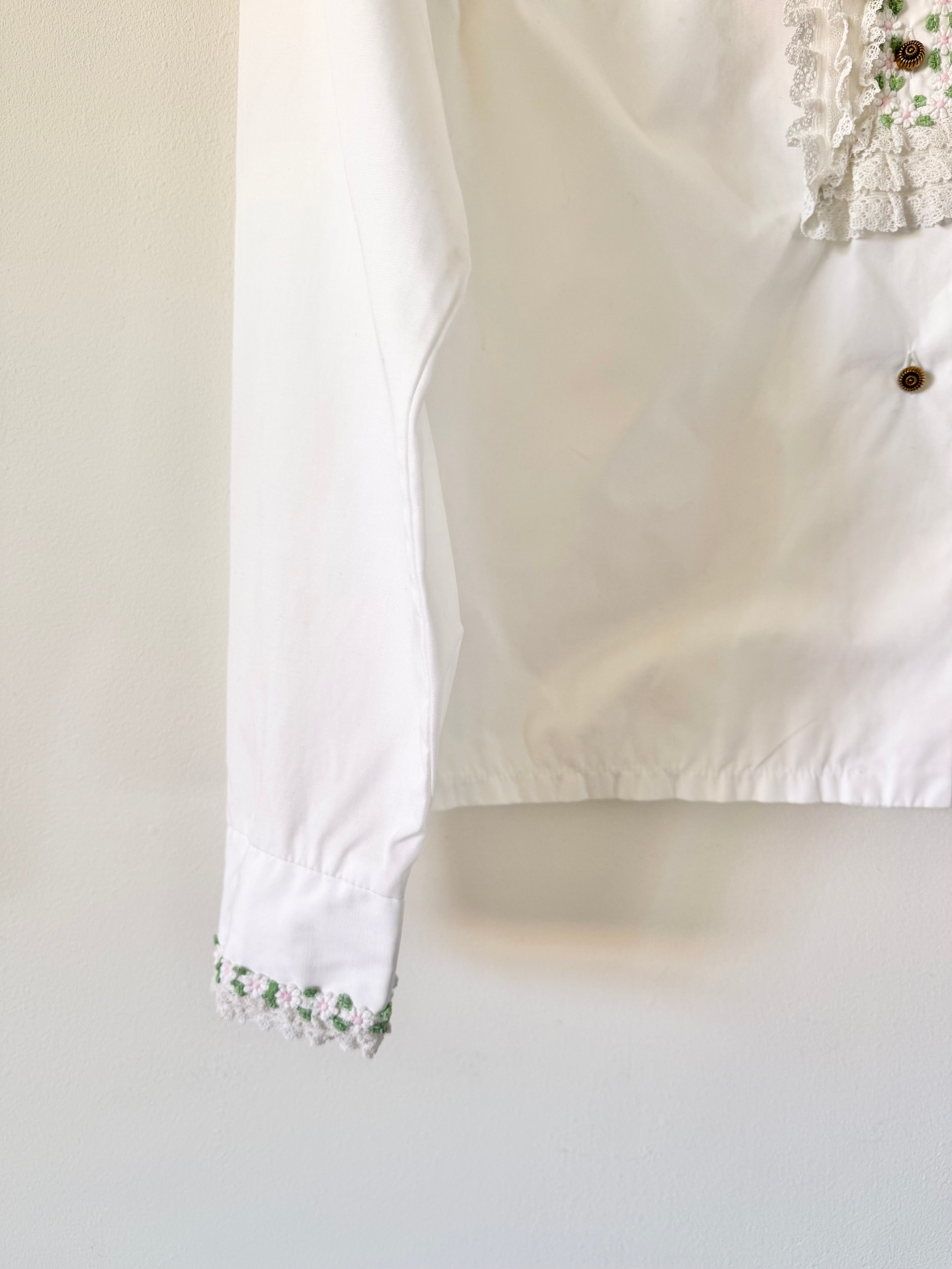 White blouse with lace detailing on a light background